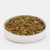 TRIM PREMIUM DE FLEURS DE CBD 100% naturel présenté dans un récipient rond, idéal pour infusions, huiles ou vaporisation. Produit Herbalcura France riche en CBD.